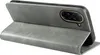 A grey flip cover case for a smartphone is shown standing upright, with the front flap open. Produktbild-Vorschau