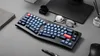 A keyboard is placed on a desk with other office supplies. Anteprima dell’immagine prodotto