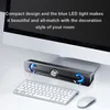 A computer speaker bar is placed in front of a monitor, with a keyboard and mouse on the desk. Produktbild-Vorschau