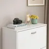 A white shoe cabinet with a camera and decorative items on top. Náhľad obrázku produktu