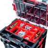 A close-up, overhead view of an open tool organizer box filled with various tools and hardware. Náhled obrázku produktu