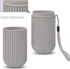 Two gray toothbrush holders are displayed against a white background. One is shown separately, and the other is shown with its lid on and a lanyard attached. Produktbild-Vorschau