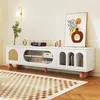 A white TV cabinet with decorative elements and artwork displayed in a living room setting. Anteprima dell’immagine prodotto