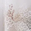 A close-up view of white lace fabric with a floral pattern. Náhled obrázku produktu