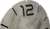 A close-up of a clock face showing the number 12 and some hour markers. Produktbild-Vorschau