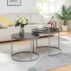 A living room scene with a couch, coffee tables, and a plant. Voir les images du produit