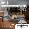 A pug dog is lying on a raised dog bed indoors, with a dining room set in the background. A smaller inset image shows the dog bed with a canopy. Produktbild-Vorschau