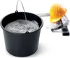 A black bucket filled with gray material, with construction safety equipment in the background. Anteprima dell’immagine prodotto