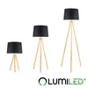 Three floor lamps of varying sizes with black shades and wooden tripod bases are displayed against a white background. A logo is present at the bottom right. Podgląd zdjęcia produktu
