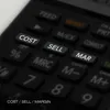 A close-up view of the buttons on a black calculator, highlighting the 'COST', 'SELL', and 'MAR' buttons. Voir les images du produit