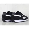 A pair of black Reebok sports shoes with white accents, shown from a side-rear angle against a textured gray background. Produktbild-Vorschau