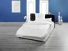 A neatly made bed with white bedding in a room with blue walls and a gray floor. Produktbild-Vorschau
