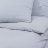 A close-up view of a gray bedding set, showing a pillow and a duvet cover. Náhled obrázku produktu