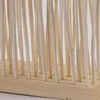 A close-up view of a room divider made of natural wood sticks. Náhľad obrázku produktu