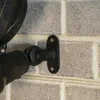 A close-up of a solar-powered spotlight mounted on a brick wall. Produktbild-Vorschau