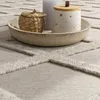 A close-up view of a rug with decorative items on it. Anteprima dell’immagine prodotto