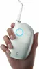 A hand holding a green and white water flosser. Náhled obrázku produktu