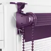Close-up of a purple roller blind mechanism attached to a white window frame. Produktbild-Vorschau