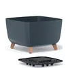 A square planter with copper-colored legs and a separate drainage insert. Náhled obrázku produktu
