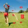 A woman is playing golf on a sunny day, with numbered targets and golf balls on the course. Náhled obrázku produktu