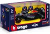 A toy Red Bull Formula 1 car in its packaging, with two driver figures visible behind it. Náhled obrázku produktu
