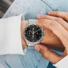 A person wearing a watch and jeans. Produktbild-Vorschau