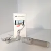 A DJI Osmo Mobile 7 smartphone gimbal and its packaging are displayed on a white surface. Voir les images du produit