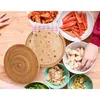 A top-down view of a table with ingredients for making tacos or wraps, including tortillas, chicken, peppers, and onions, with hands reaching for the ingredients. Anteprima dell’immagine prodotto