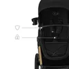 A close-up view of a black Kinderkraft stroller, highlighting its features with graphic overlays. Náhled obrázku produktu