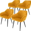 Four mustard yellow dining chairs with black legs are arranged in a staggered formation against a white background. Produktbild-Vorschau