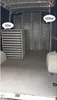 The inside of a van filled with stacked catering tables. Produktbild-Vorschau