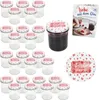 A set of small glass jars with decorative lids, a jar filled with jam, and a recipe booklet. Produktbild-Vorschau