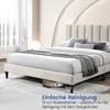 A bed with a beige upholstered headboard and frame, with a robot vacuum cleaner underneath, in a bedroom setting. Náhľad obrázku produktu