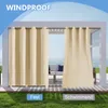 Outdoor curtains hanging on a patio or pergola structure with a view of the water in the background. Produktbild-Vorschau