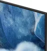 A close-up view of a television screen displaying a blue and white abstract image, with the black bezel of the TV visible on the right and top edges. Produktbild-Vorschau
