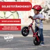 A young boy is riding a red balance bike outdoors, with graffiti-style art in the background. Text overlays highlight product features. Produktbild-Vorschau