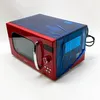 A red Comfee retro-style microwave oven is shown from a three-quarter angle on a white background. The top and back of the microwave are covered in blue plastic protective film, with some text and labels visible on the film. Anteprima dell’immagine prodotto