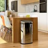 A modern kitchen with a wooden island and a stainless steel trash can. Anteprima dell’immagine prodotto
