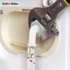 A close-up view of a washing machine inlet hose being connected to a water valve using an adjustable wrench. Náhled obrázku produktu