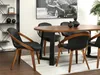 A dining room scene with a wooden table and chairs, a large framed picture on the wall, and a bookshelf. Voir les images du produit