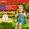 A young girl is happily swinging on a green swing in a park-like setting. Anteprima dell’immagine prodotto