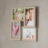 A collage of family photos and a decorative heart, mounted on a textured wall. Produktbild-Vorschau
