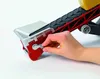 A hand is shown turning a crank on a toy conveyor belt. Náhled obrázku produktu