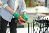 A person is using a belt sander to work on a metal railing outdoors. Náhľad obrázku produktu