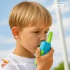 A young boy holding a walkie-talkie to his mouth, with a blue sky in the background. Anteprima dell’immagine prodotto