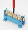 A close-up shot of an electrical terminal block with a screwdriver tightening a screw. Produktbild-Vorschau