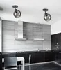 A modern kitchen with sleek dark cabinets, a gray tiled backsplash, and stainless steel appliances. Two pendant lights hang from the ceiling. Produktbild-Vorschau