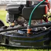 Close-up of a lawnmower engine with a water hose attached for cleaning. Produktbild-Vorschau