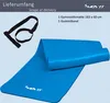 A blue yoga mat is shown rolled up and unrolled, with a black carrying strap. Text indicates the scope of delivery and product details. Podgląd zdjęcia produktu