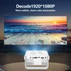 A white mini projector is shown in the foreground, projecting a vibrant image of a sunset beach scene onto a large screen in the background. Text overlays highlight the projector's capabilities. Produktbild-Vorschau